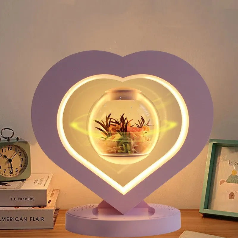 Pink preserved rose ornament gift with optional Bluetooth audio base on a wooden table.