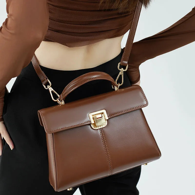 Women's black leather shoulder bag with vachette clasp and horizontal square shape