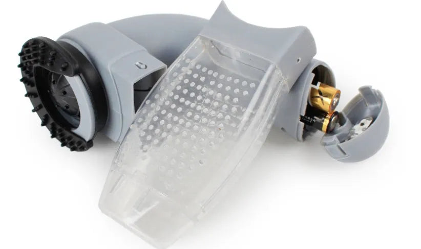 Grey portable pet hair vacuum cleaner with soft rubber grooming head on a fabric sofa