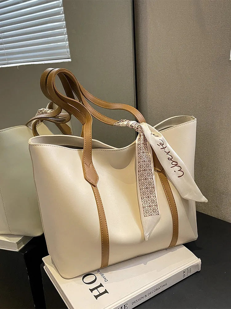 Women's soft bucket tote bag in multiple colours with crossbody strap and zippered internal compartment