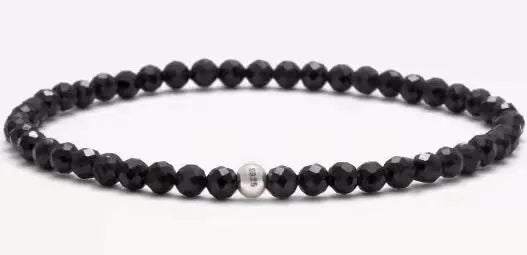 A unisex beaded bracelet with small 4mm obsidian, blue San, and black agate stones in geometric shapes.