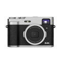 Black or brown 5K digital camera with dual lenses, optical viewfinder, and 2.88-inch screen.