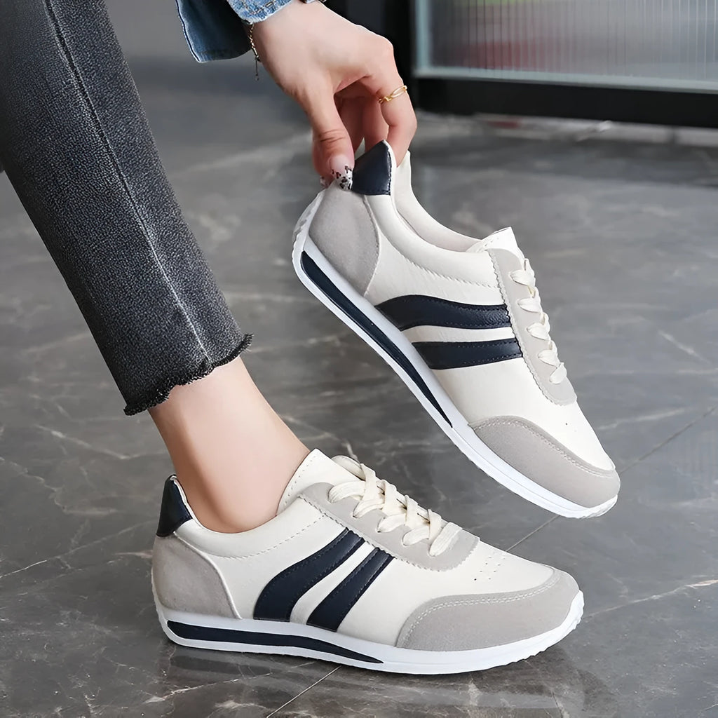 Blue and red lace-up low-top sneakers with a round toe and soft rubber sole.