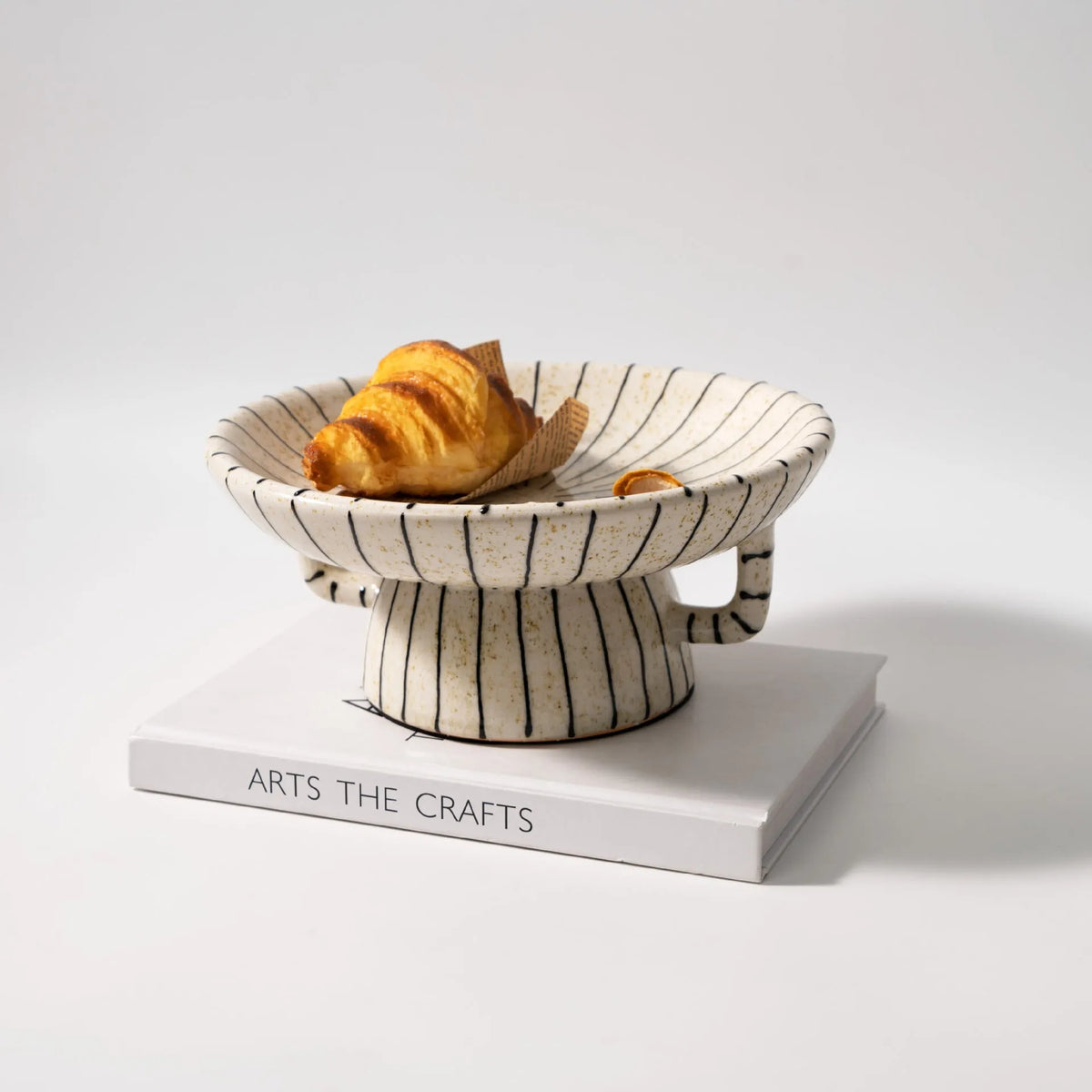 Black and white striped retro fruit plate on table with dessert