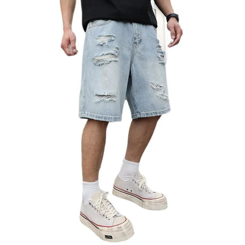 Light blue ripped denim shorts with distressed detailing and loose straight-leg cut