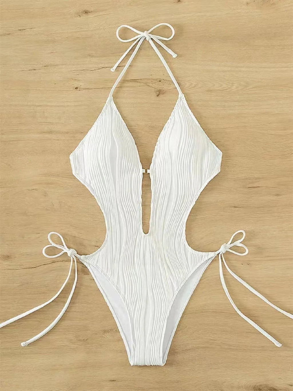 Women's black triangle bikini with lace-up detailing on white background