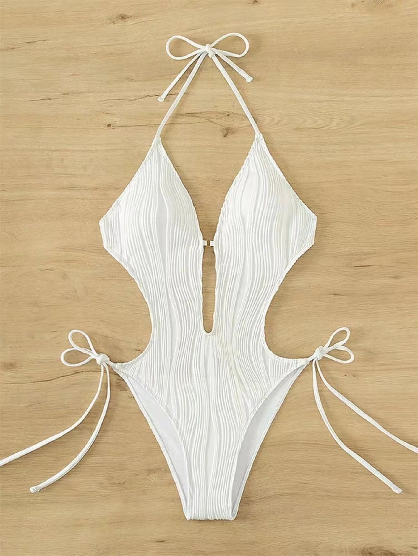 Women's black triangle bikini with lace-up detailing on white background
