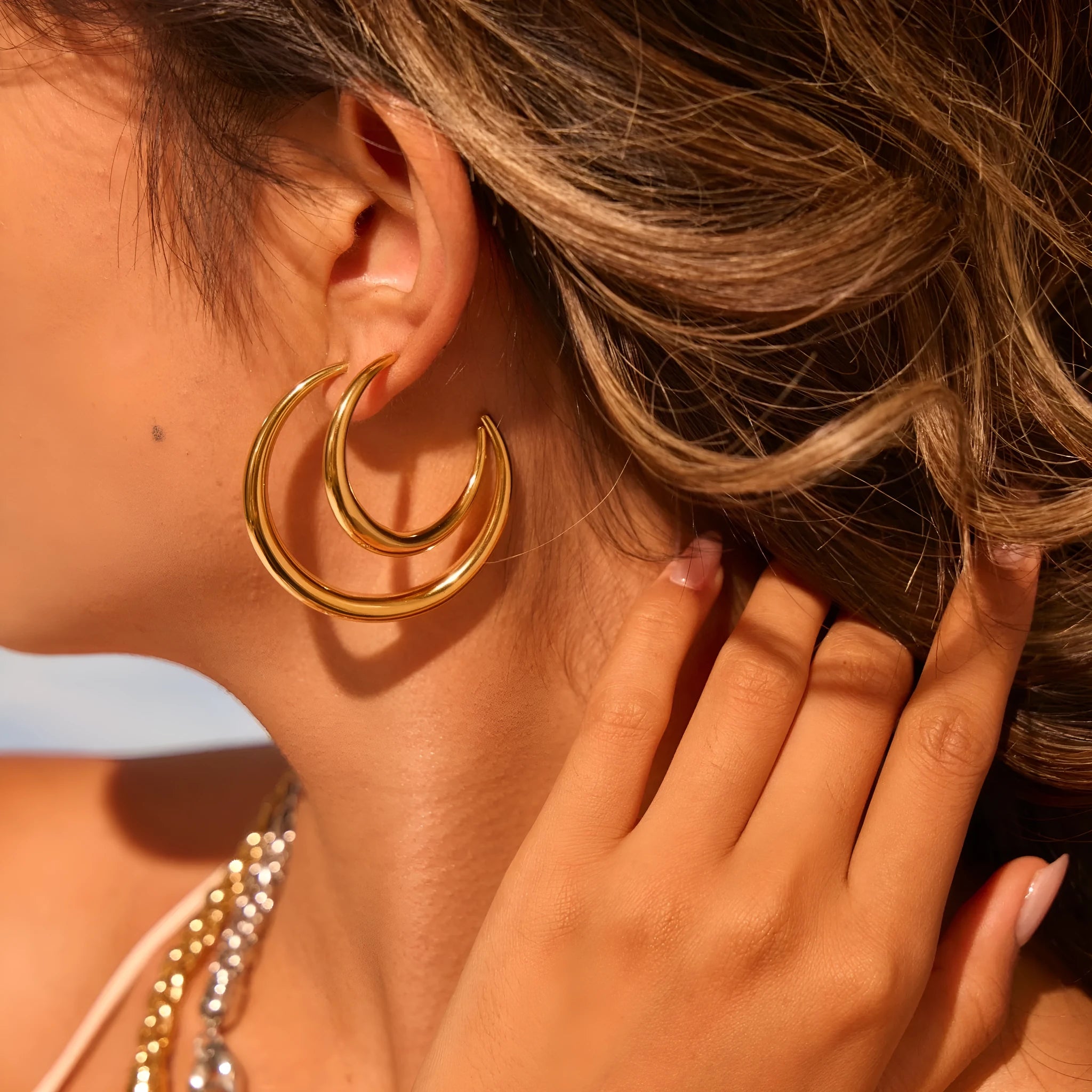 Titanium steel hoop earrings in geometric round design with gold or steel finishes
