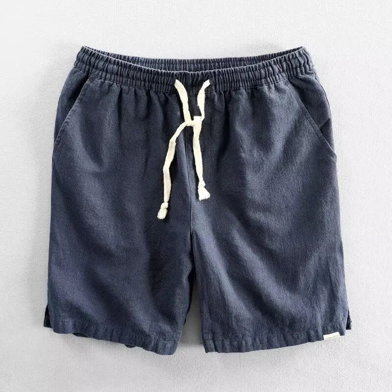 Man wearing loose-fitting cotton and linen casual shorts in a straight-leg style with an elasticated waist.