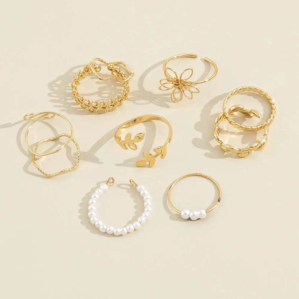 Gold coloured openwork floral design alloy ring set for women, showing glossy electroplated finish.