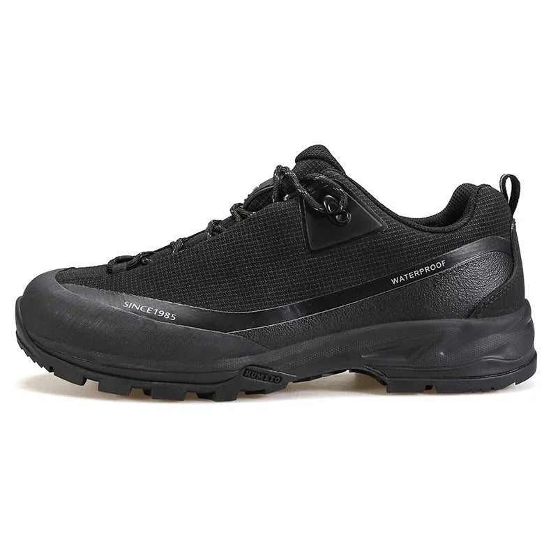 Men's low-top mountain climbing shoes in black with leather mesh upper and non-slip rubber outsole
