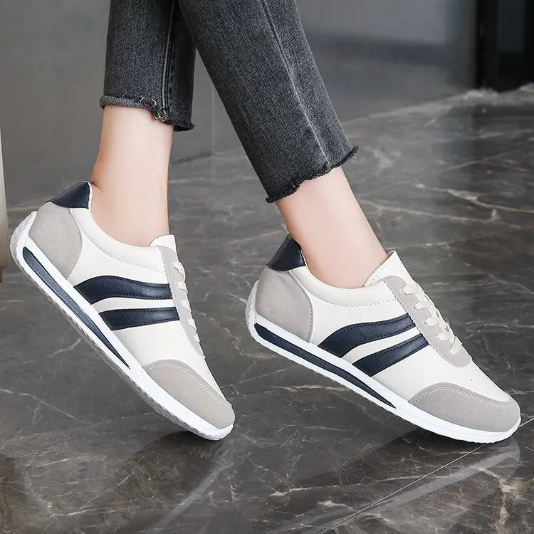 Blue and red lace-up low-top sneakers with a round toe and soft rubber sole.