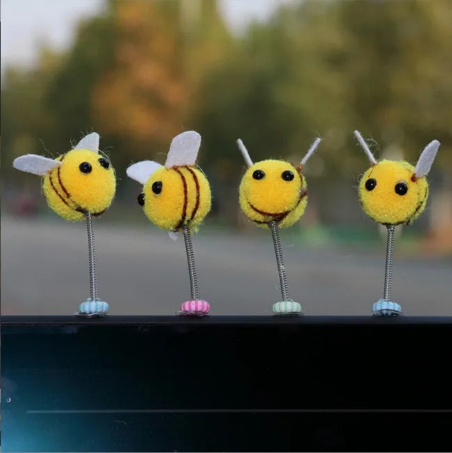 Small yellow and black fur ball bee car decoration ornament measuring 3cm.