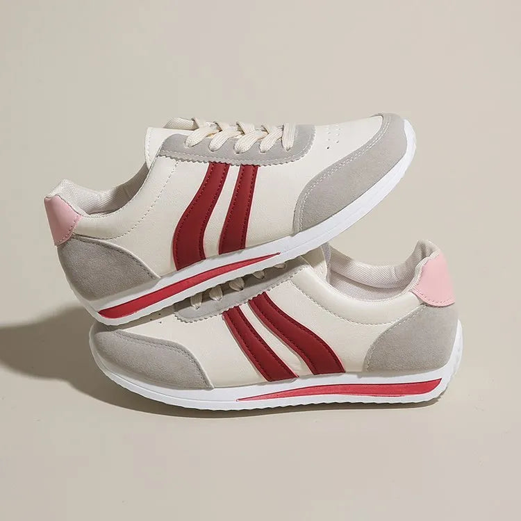 Blue and red lace-up low-top sneakers with a round toe and soft rubber sole.