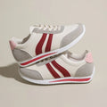 Blue and red lace-up low-top sneakers with a round toe and soft rubber sole.