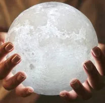 3D printed white moon lamp on a wooden stand with touch-control ring at base