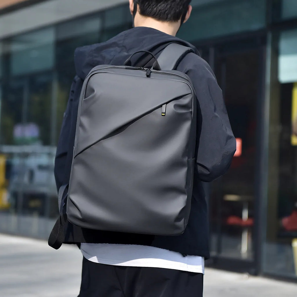Simple black PU leather backpack with visible sewing thread detailing and large storage capacity
