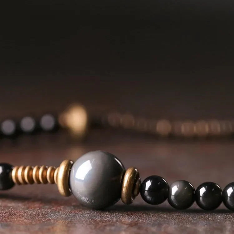 Black multi-layered beaded bracelet with geometric shapes and colourful retro patterns
