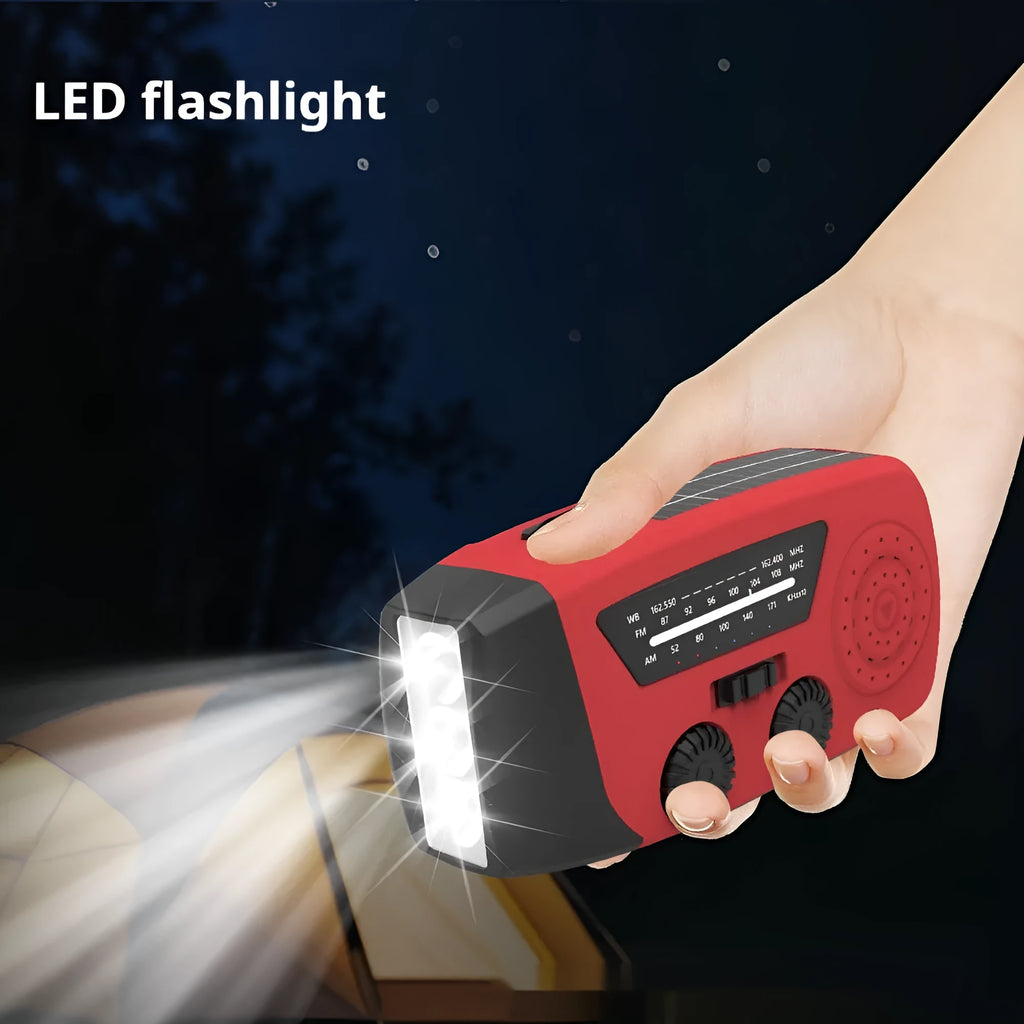 Red rechargeable emergency hand radio torch with USB port and wrist strap for disaster preparedness