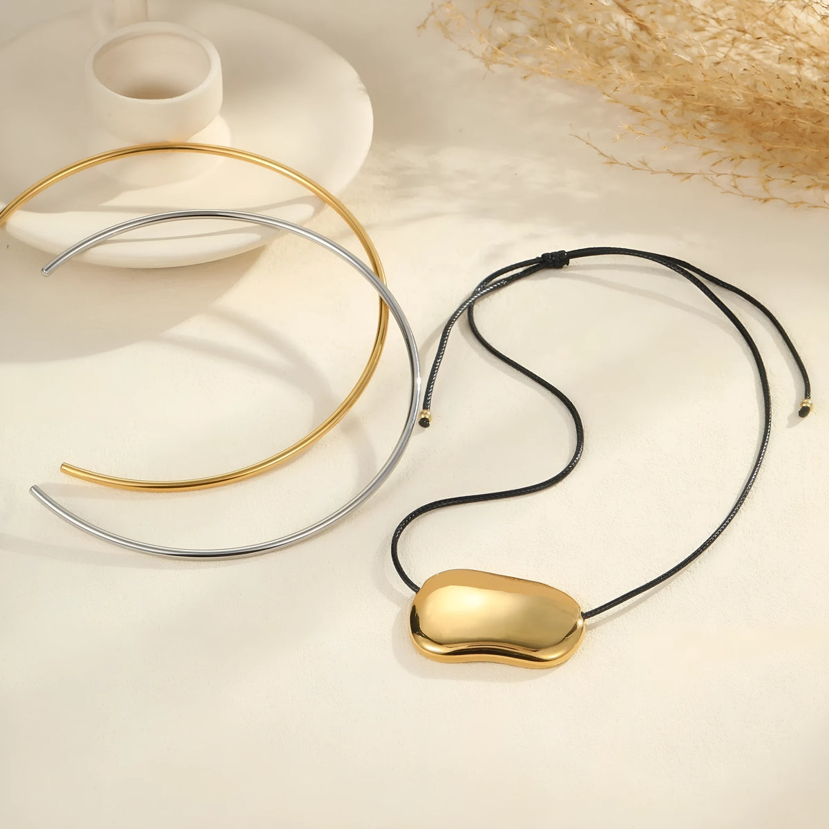 Black rope titanium steel necklace with geometric pendant in gold or silver finish on model