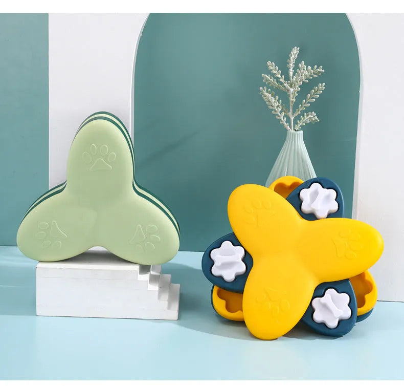 Green and yellow dog puzzle toy with bone covers and rotatable treat dispenser on non-slip base