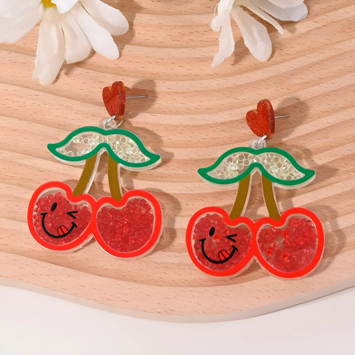 Set of acrylic earrings shaped like cherry, strawberry, watermelon, pineapple, coconut, cake, and ice cream.