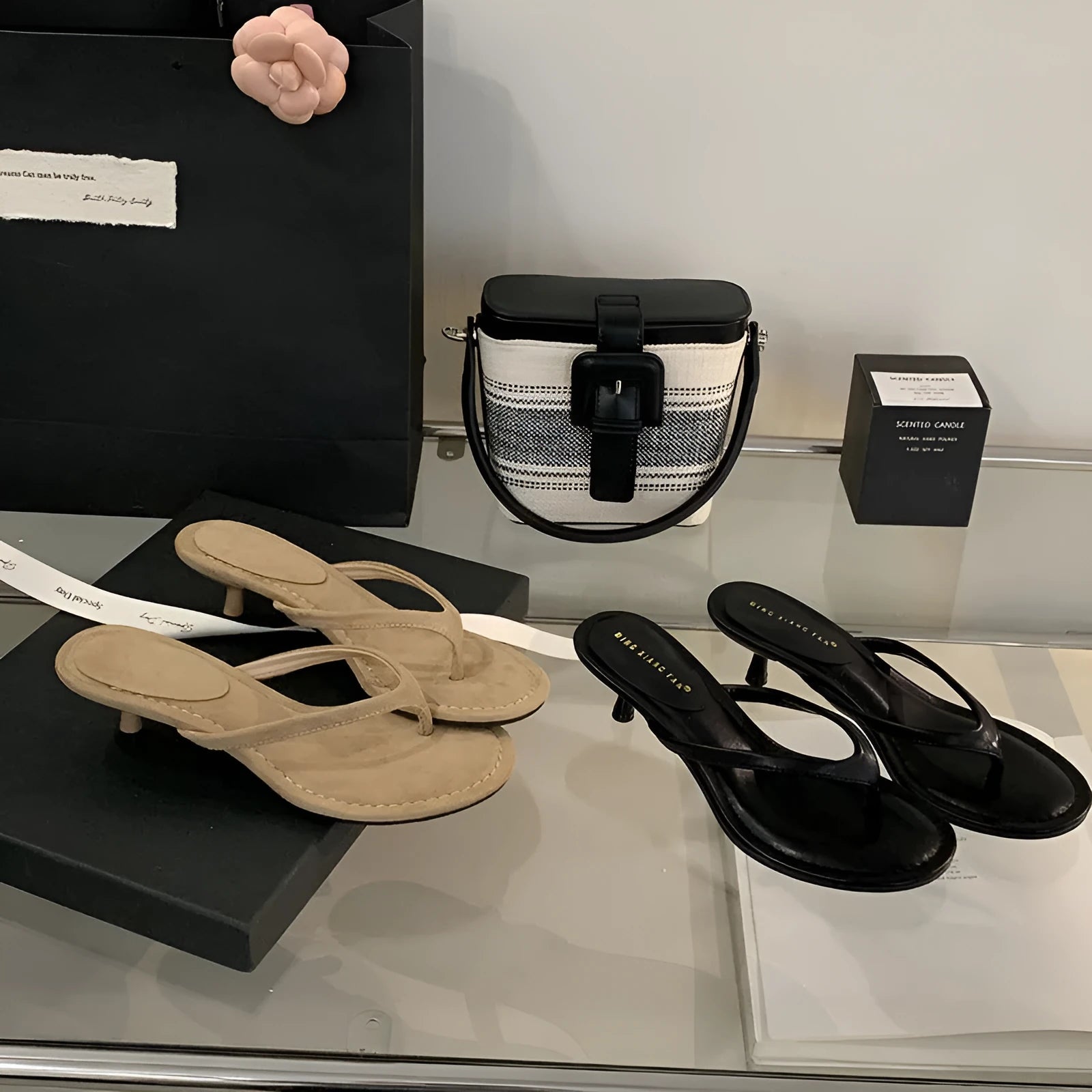Women's black rubber flip-flop sandals with stiletto heel and round toe on a white background