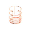 Rose gold iron wire square pen holder on desk holding pens and a ruler