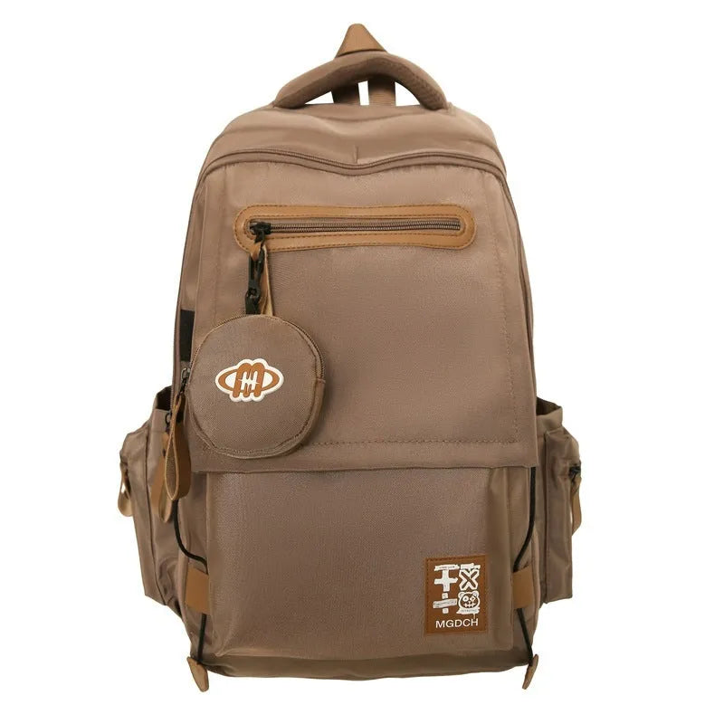 Large black nylon backpack for middle school students with curved shoulder straps and sewing line details