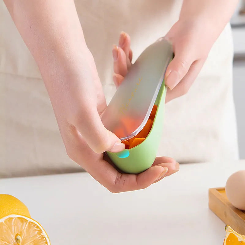Green kitchen peeler with stainless steel blade stored inside a clear plastic tube.
