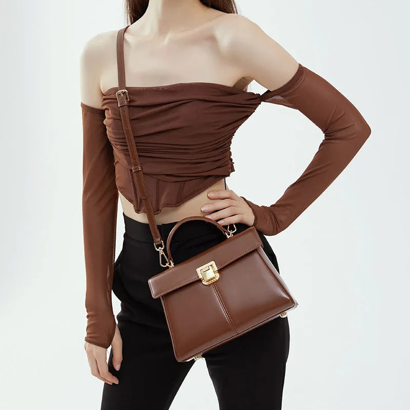 Women's black leather shoulder bag with vachette clasp and horizontal square shape