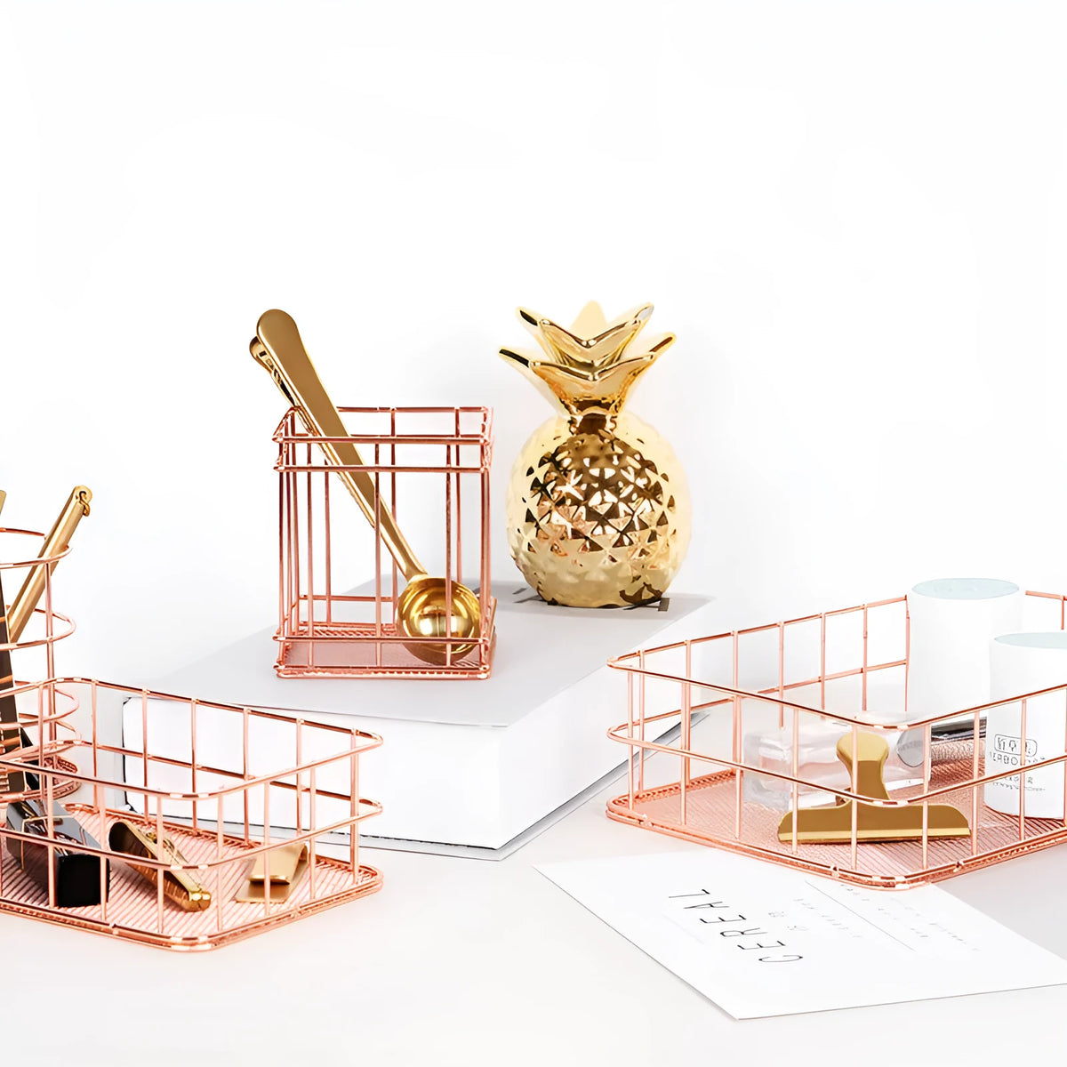 Rose gold iron wire square pen holder on desk holding pens and a ruler