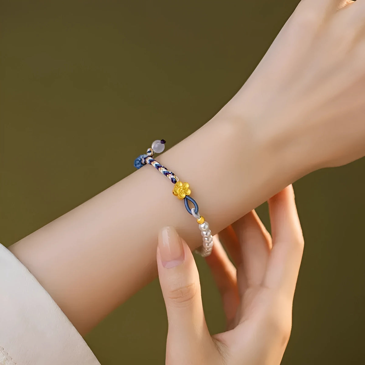 Peach-coloured cord bracelet with sterling silver Chinese flower weaving, chalcedony and pearl details.