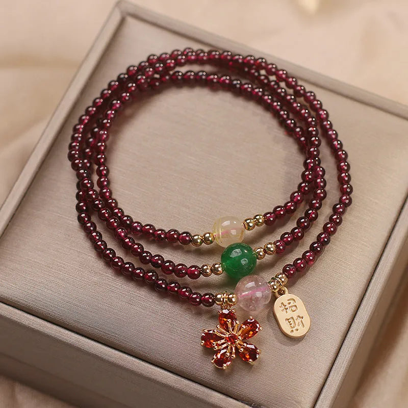 Natural crystal pomegranate red cherry blossom bracelet with sequins on wrist