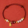 Adjustable women's bracelet with Hetian jade, cinnabar red rope, and 925 silver components