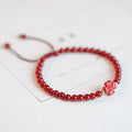 Hand-woven red agate bracelet with ethnic style design and diamond-shaped beads