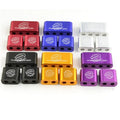 Three-piece metal car modification fastening clamp in assorted colours on a white background.