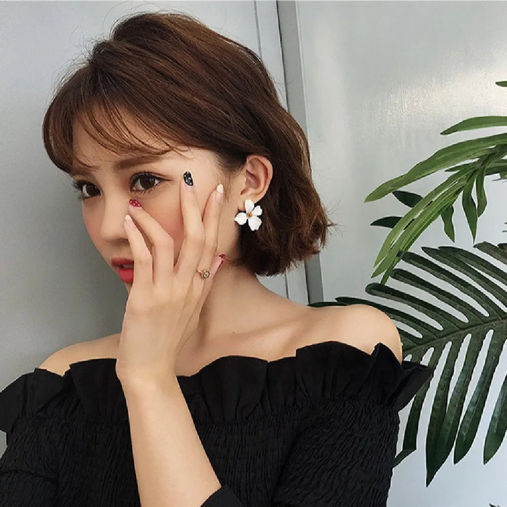 Flower design stud earrings for women in white or pink electroplated finish