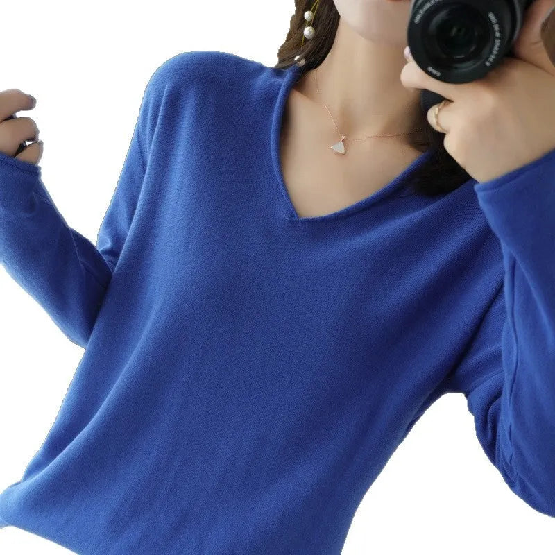 Women's long sleeve V-neck knitwear top in turmeric colour, laid flat to show pullover style and non-ironing fabric.