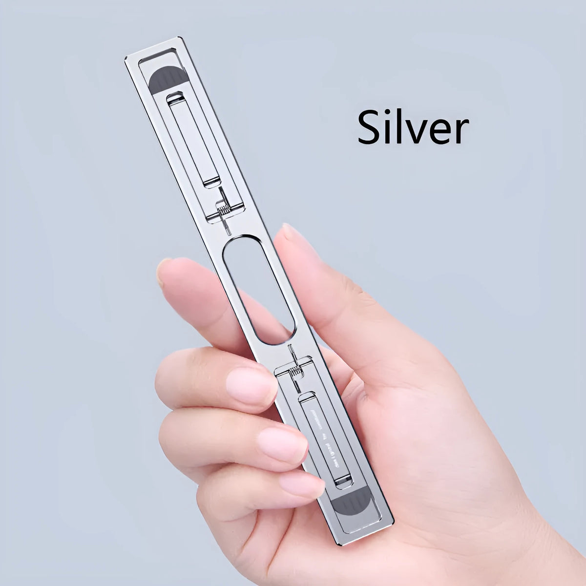 Aluminium alloy adjustable laptop cooling bracket in silver on a desk raising a notebook for better airflow and ergonomics