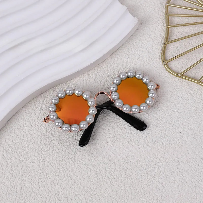 Pearl-rimmed round sunglasses for a cat or dog, shown in blue, with size options of 11cm and 8cm.