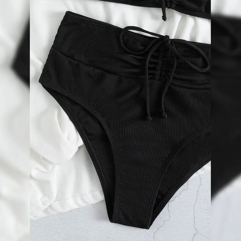 Black women's swimsuit with high waist bottoms and sleeveless top on mannequin