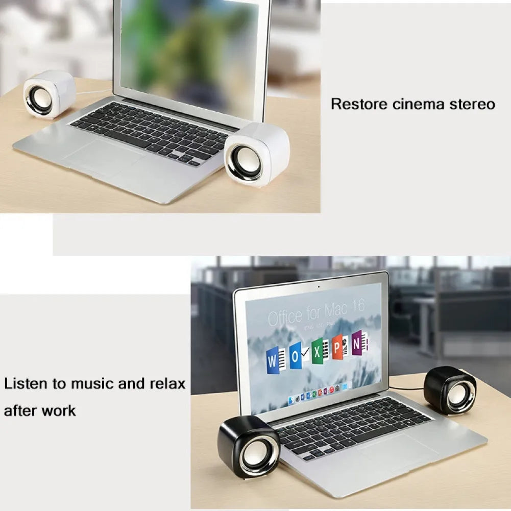A pair of compact black or white wired desktop computer speakers with a 3.5mm plug, shown next to a laptop.