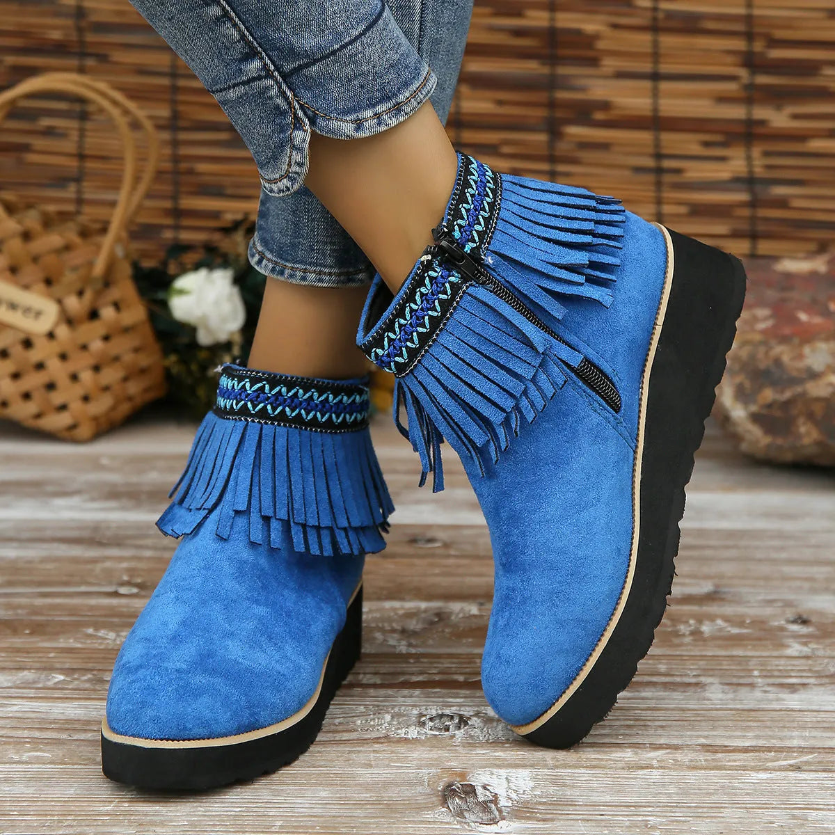 Women's suede ankle boot with wedge heel, side zipper, tassel detail, and thick rubber sole in three colour options.