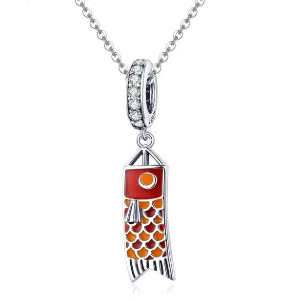 S925 sterling silver carp streamer pendant with zircon detailing on a dark background