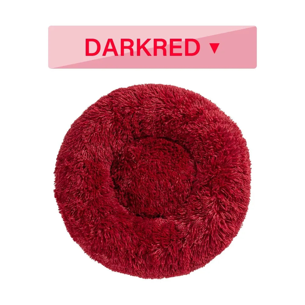 Fluffy donut-shaped dog bed with raised rim in plush fabric, available in multiple colours and four sizes