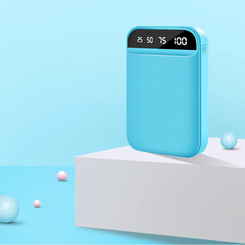 Compact mini power bank in black, blue, pink, or white, showing size compared to a hand.