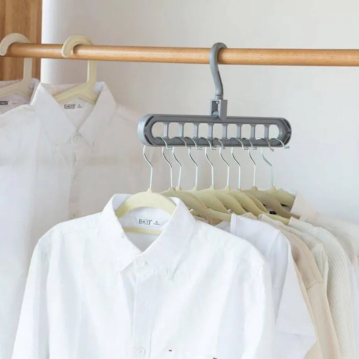 Pink plastic clothes hanger with a 360-degree rotating hook on a white background.