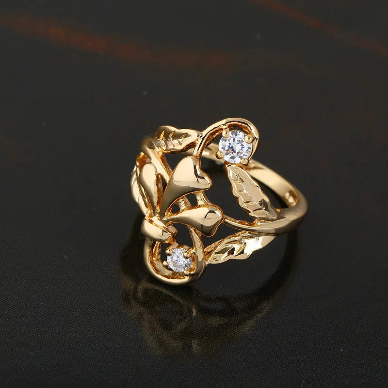 Gold tone copper ring with exaggerated irregular leaf design and white zircon stones, women's geometric band ring