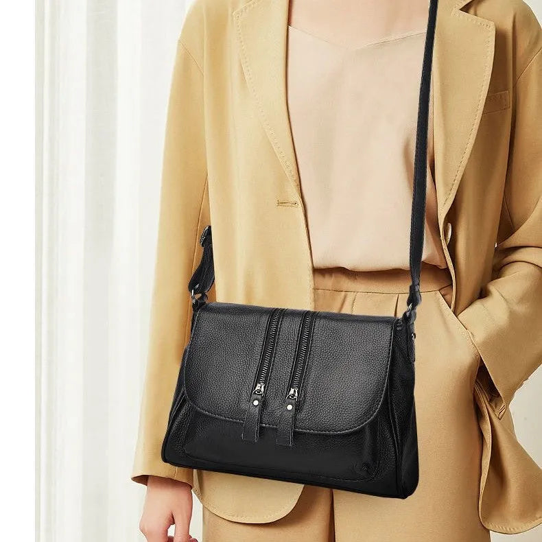 Cowhide leather shoulder handbag with chain and cover closure, 30x19x13cm, shown in wine red or light purple.